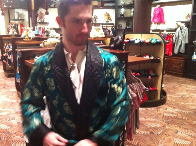 Aaron trying on Chinese robes at Epcot China