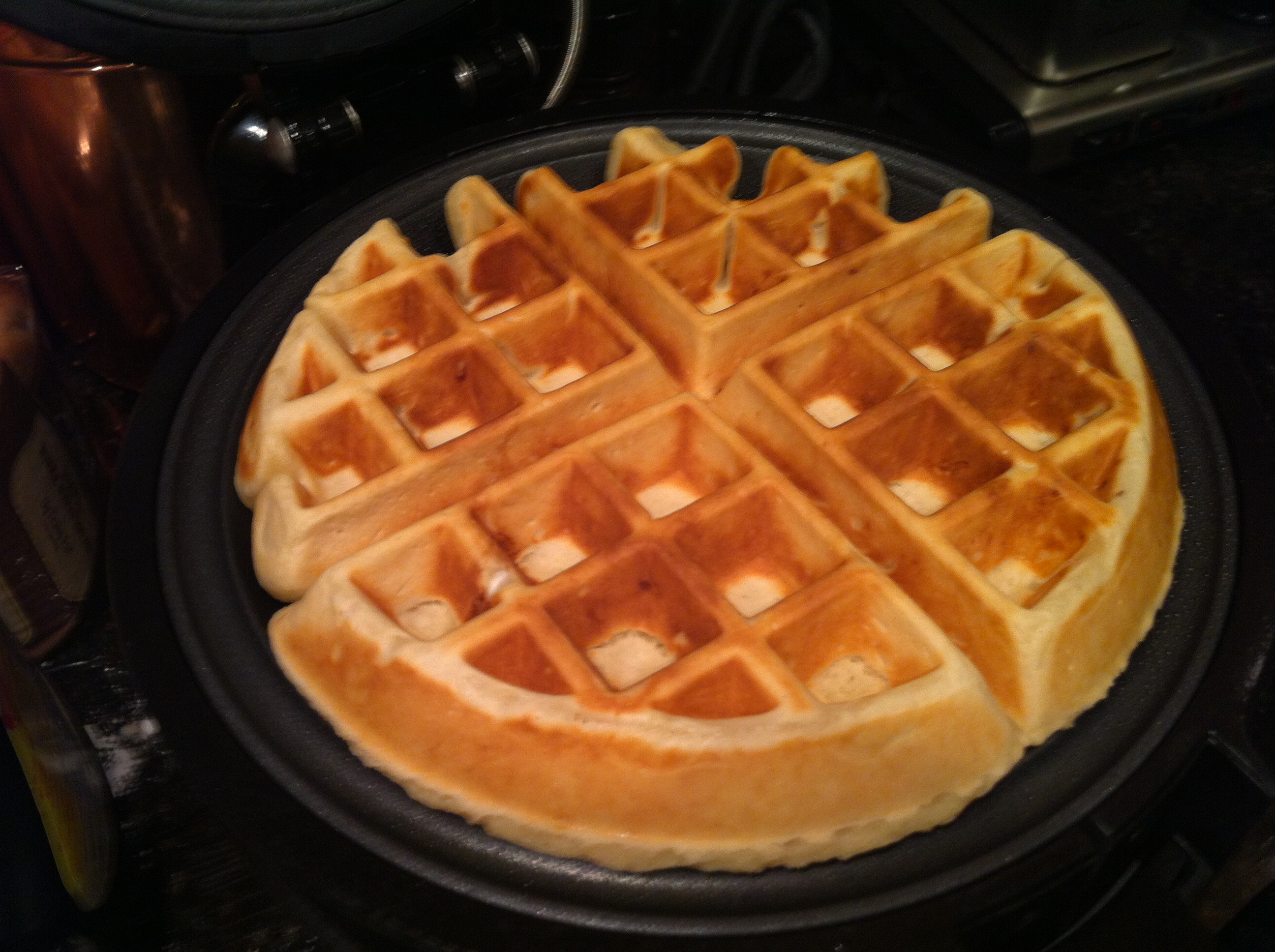 Hot, piping Belgian waffles coming out of the waffle maker