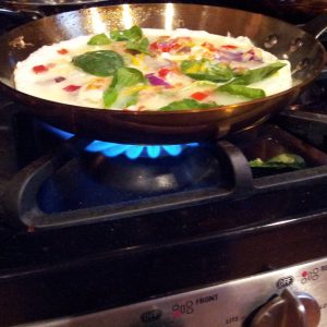 Egg White Vegetable Omelettes and Frittatas Cooking In Copper Pan Over Gas Flame