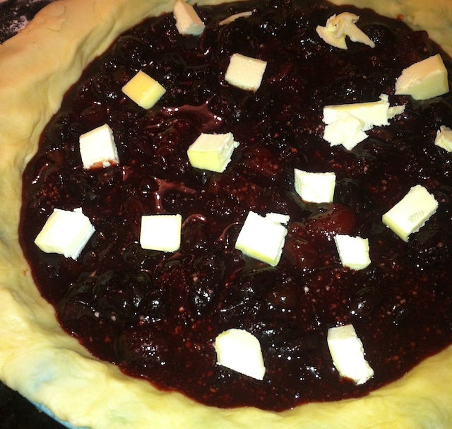Bourbon Cherry Pie with Butter During Filling Process