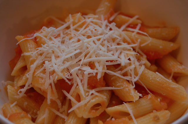 Closeup of Penne Pasta with Tomato Butter and Onion