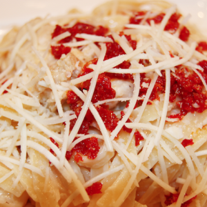 Cream and Butter Sauce with Romano Cheese Chicken and Sun Dried Tomato Closeup