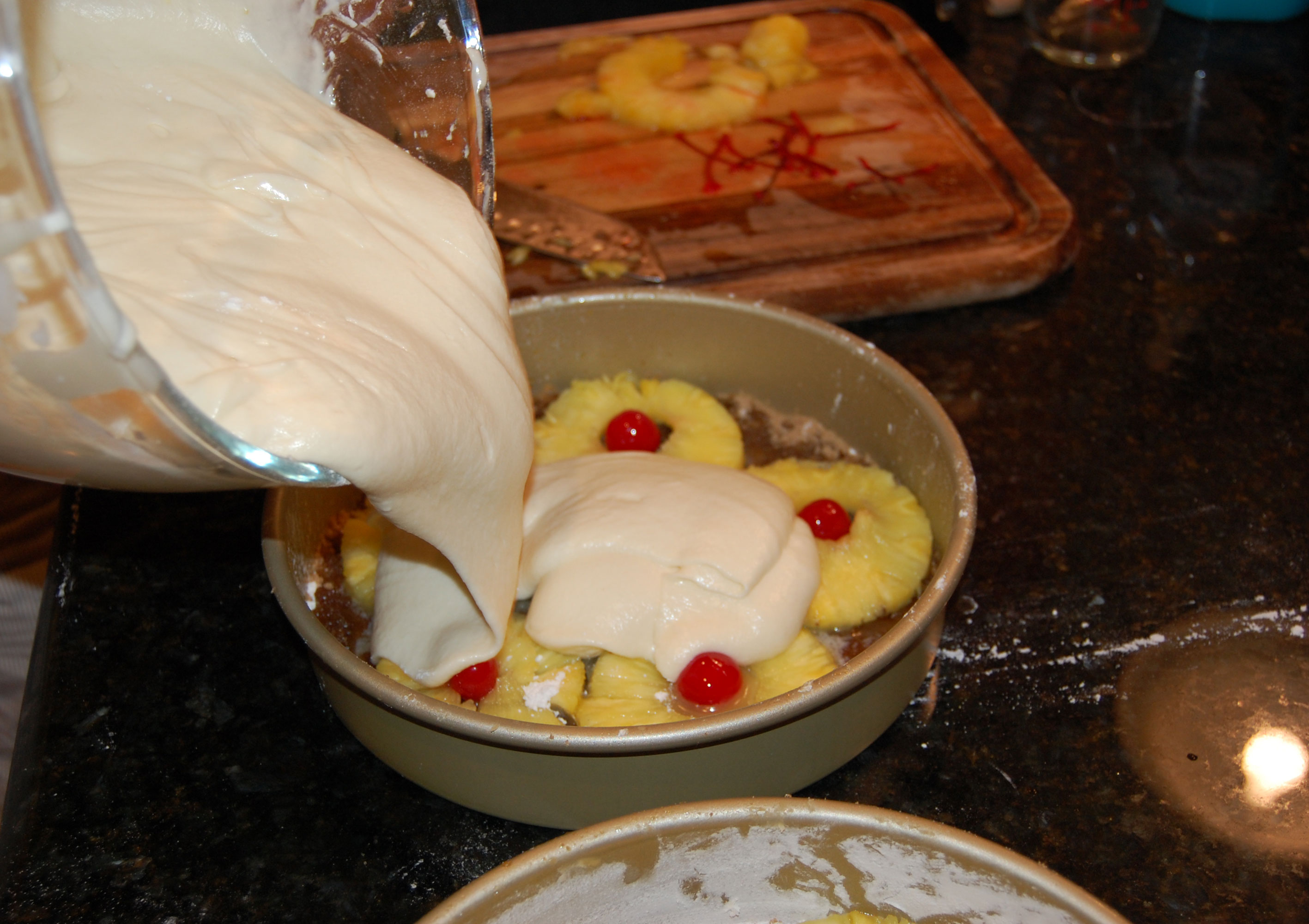 Putting the Pineapple Upside Down Cake Batter Over the Fruit and Brown Sugar Butter Mixture