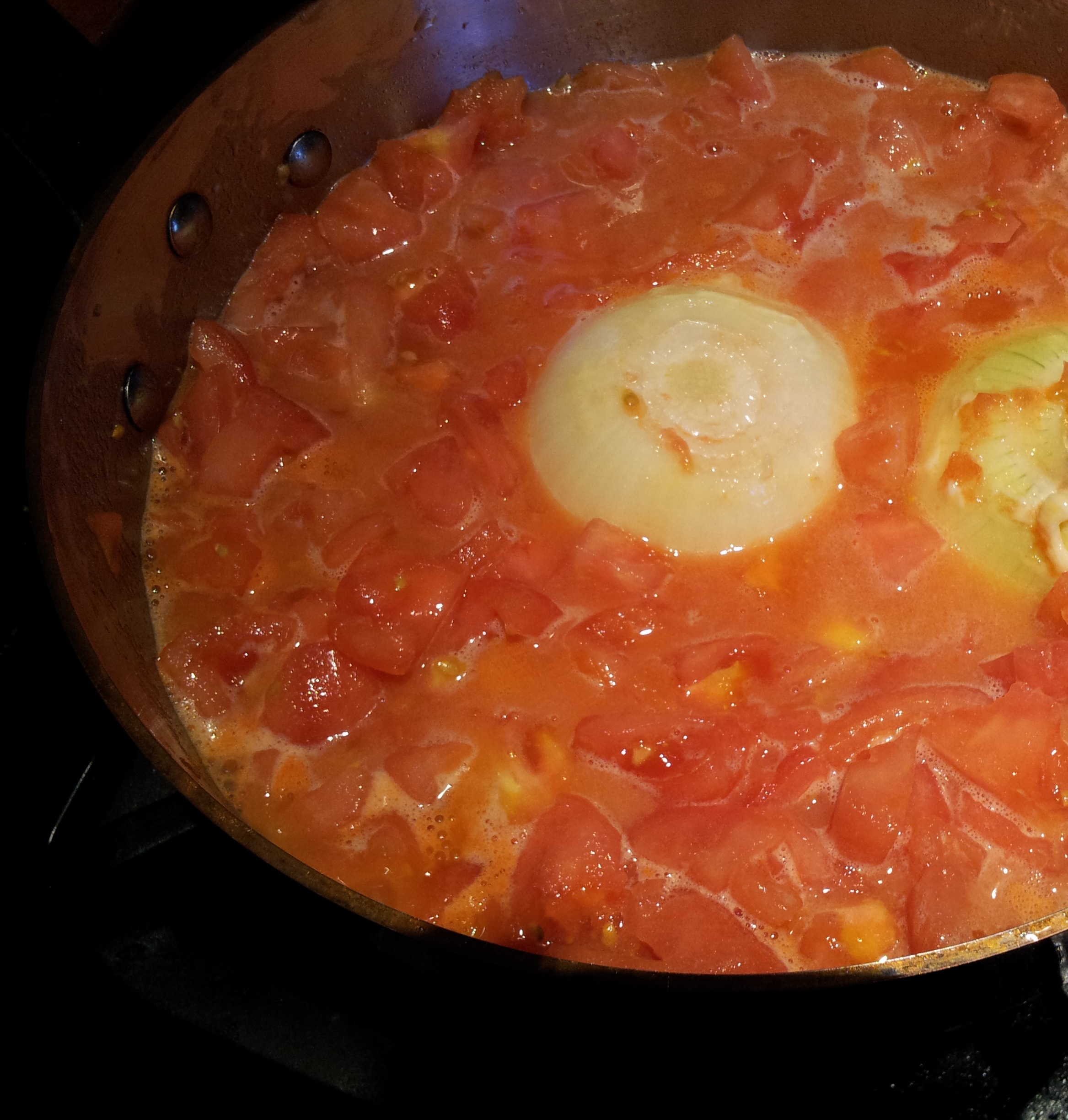 Putting the Ingredients for Butter Onion and Tomato Sauce Into Copper Pot