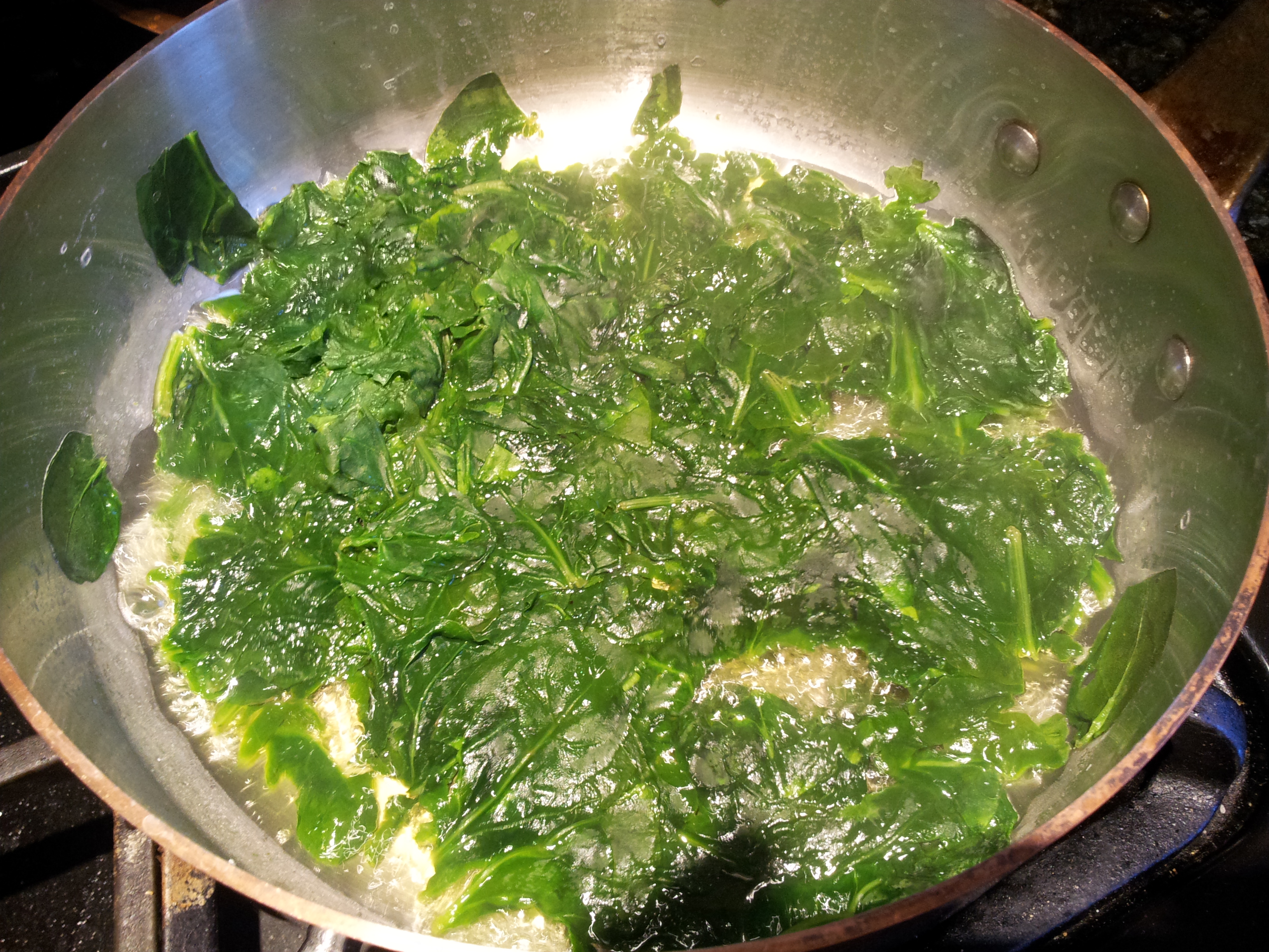 Wilted Spinach Ready to Be Drained