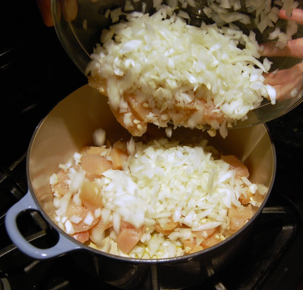 Adding the First Bowl to White Chicken Chili Recipe on Stove