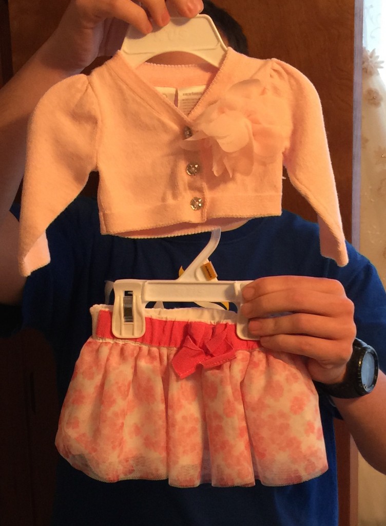 Brother Picking Out Clothes for Newest Niece
