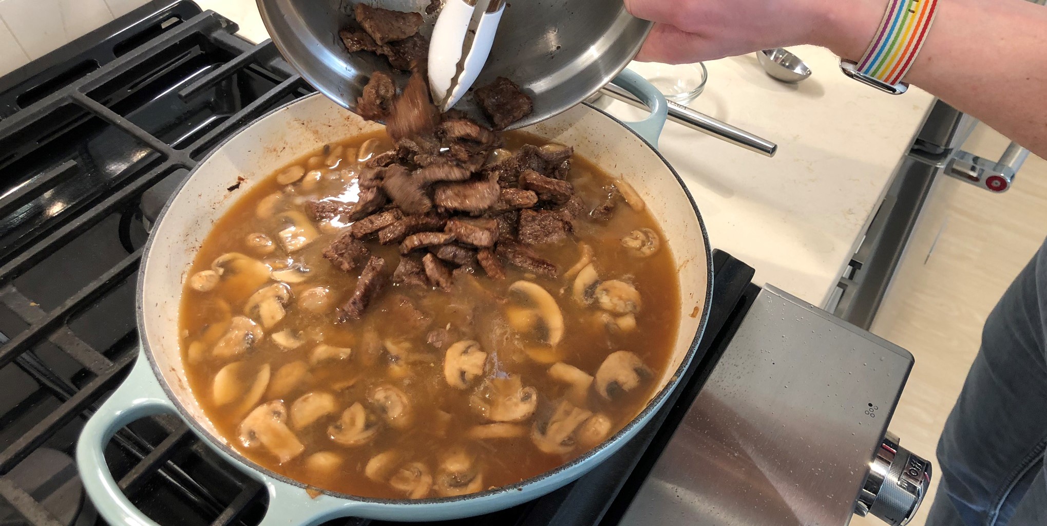 Adding the Browned Beef Back into the Beef Stroganoff Recipe for Final Simmering Stage