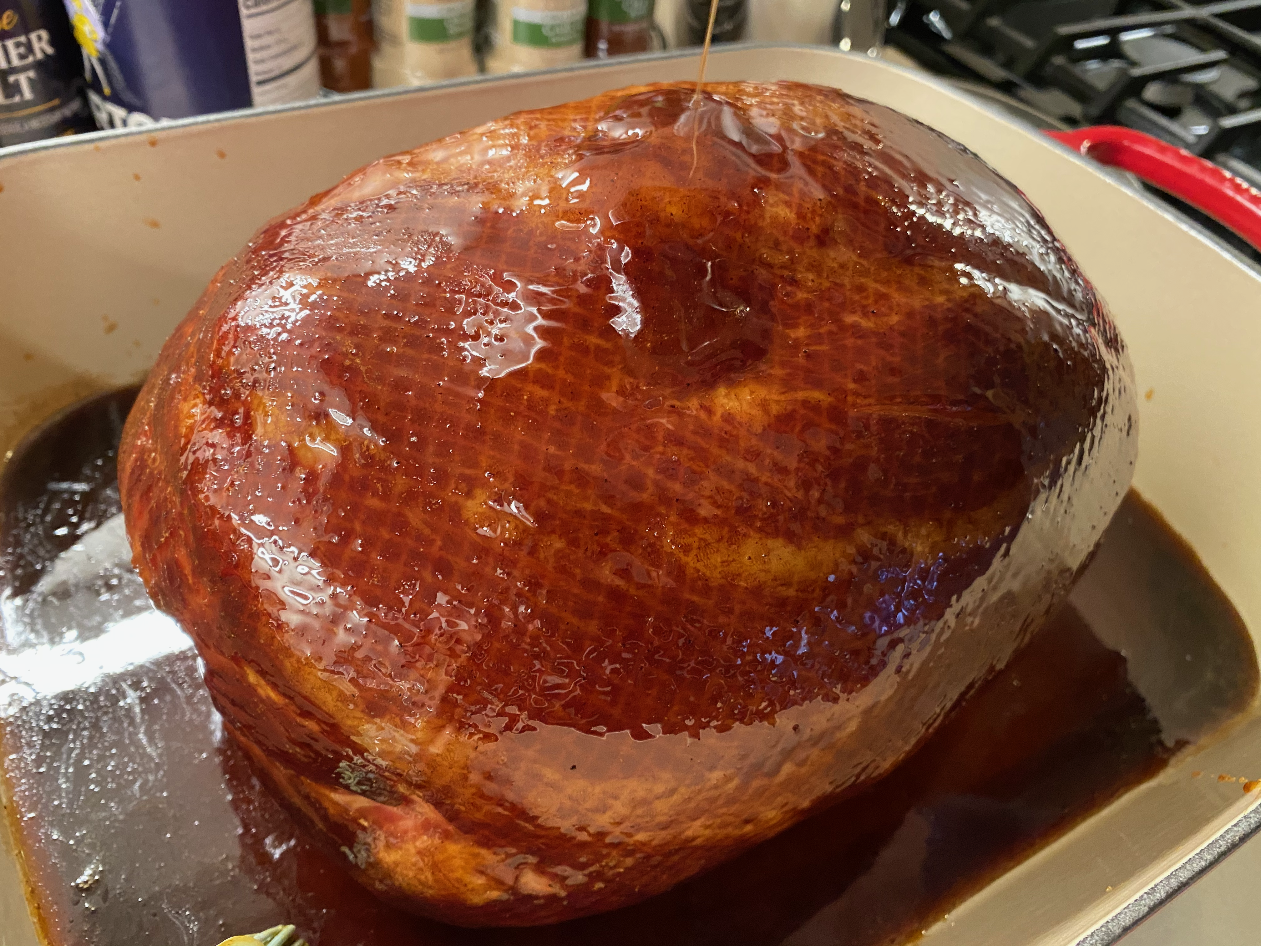 Adding the Initial Brown Sugar Honey Glaze to the Roast Ham